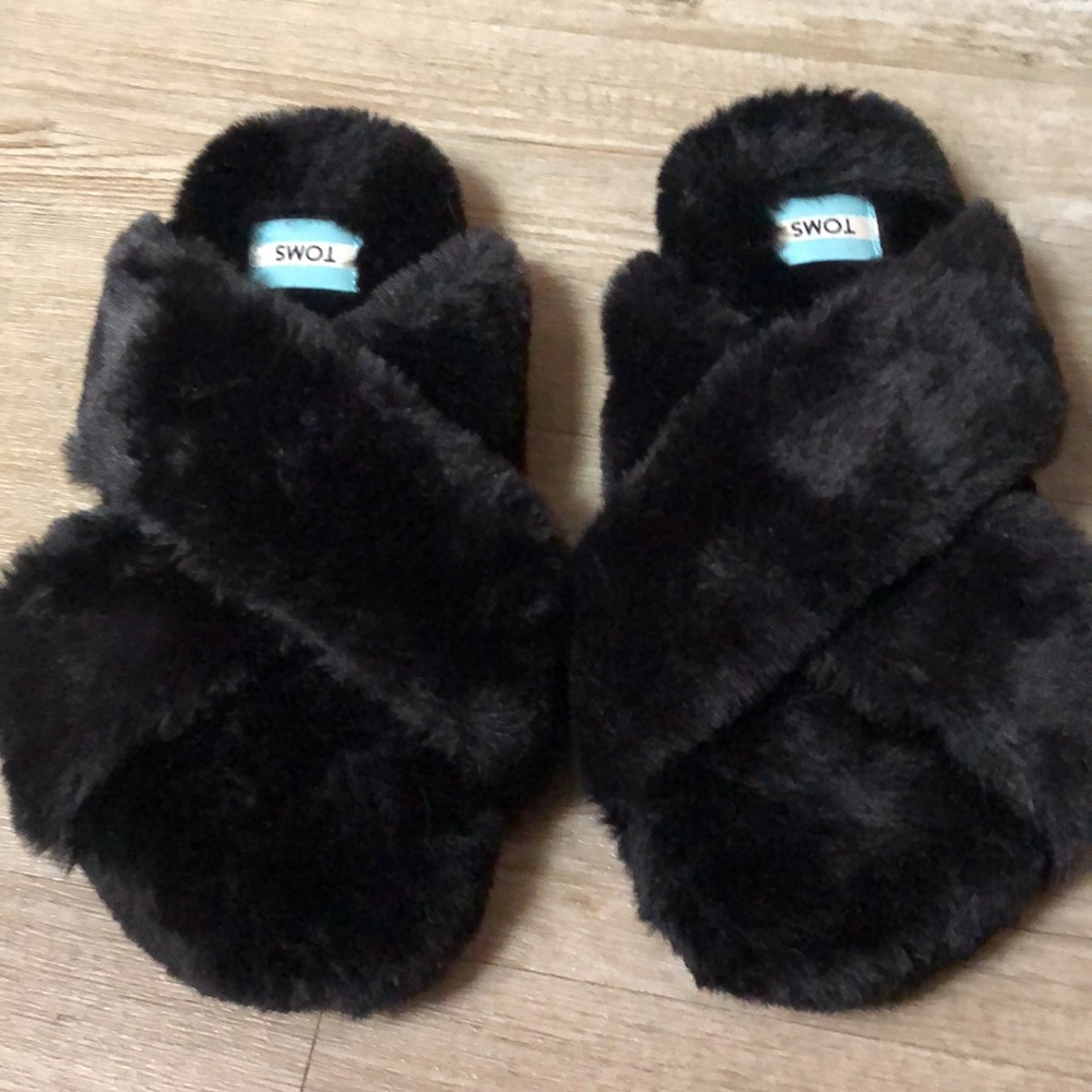 Black Toms fuffly slippers.